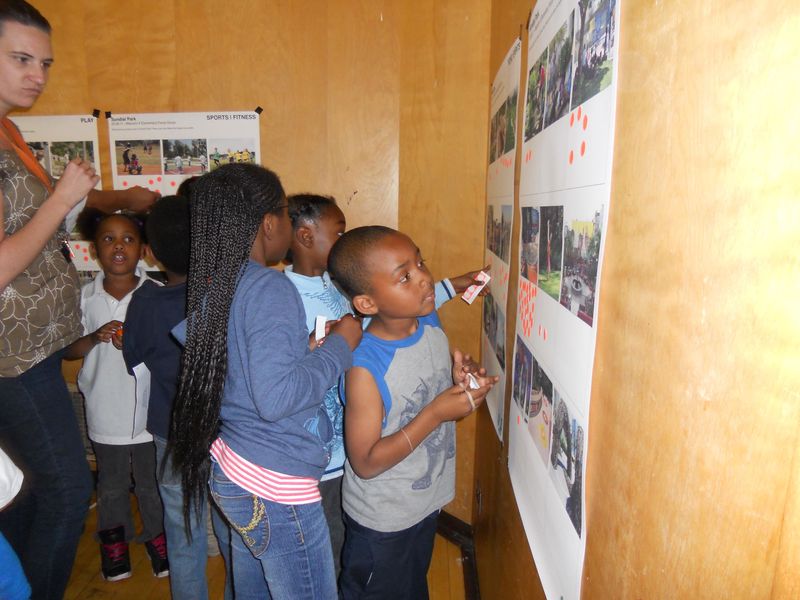 Community Members looking at renderings of Hilltop Park