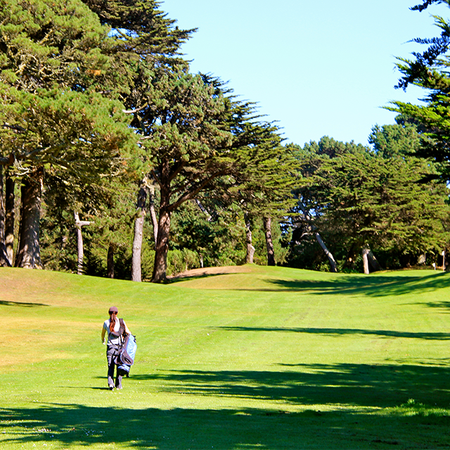 Golfer carrying bag